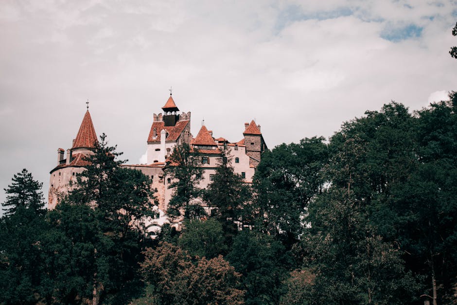 Explore the iconic Bran Castle nestled in the lush Transylvanian landscape, Romania.