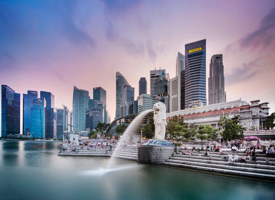 Stunning view of Singapore's skyline featuring the famous Merlion fountain at dusk.